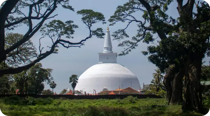 Ruwanwelisaya stupa surrounded by trees in Anuradhapura, Sri Lanka